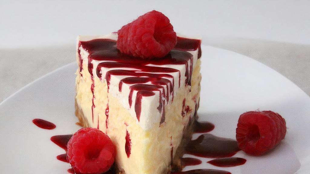 Raspberry Topping Over Cheesecake · New York-style cheesecake on top of a graham cracker crust. Topped with raspberry topping.