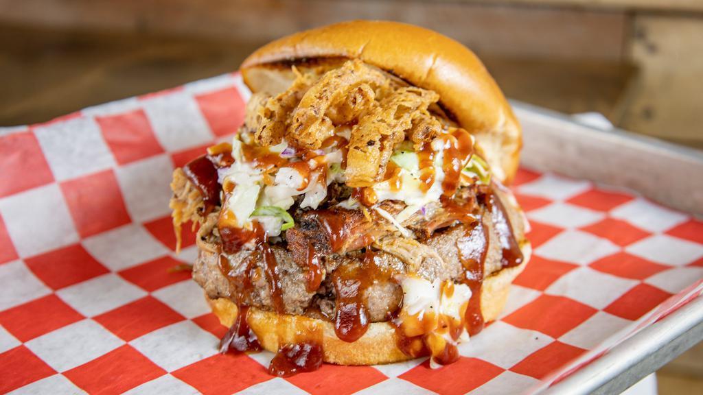 Big Bbq Burger · 1/2 pound, seasoned angus beef burger topped with smoked Pulled Pork, homemade Slaw, Fried Onion & Sweet bbq sauce.  If you are hungry, this is where its at!