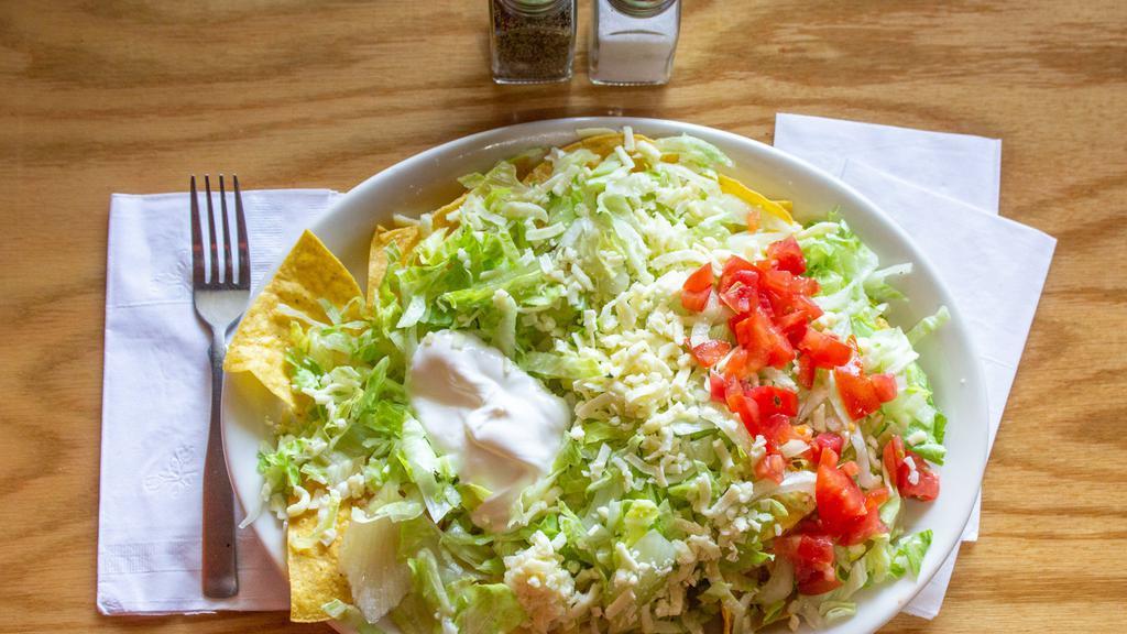 Taco Salad · A crispy tortilla bowl filled with seasoned ground beef or tender chicken, covered with lettuce, tomatoes, guacamole, cheese, and sour cream.
