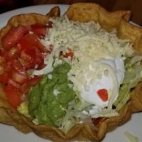 Fajita Taco Salad · A crispy tortilla bowl filled with fajita-style chicken or steak, covered with lettuce, toma...