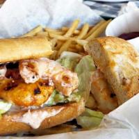 Fried Shrimp Poor Boy · All Po Boy Loafs served on Cuban bread dressed with cocktail and tartar sauce and layered wi...