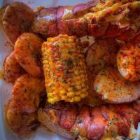 Lobster Combo · 2 Lobster tails, 5 shrimp,  egg,  corn, and potatoes; topped with garlic butter sauce