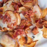 Tavern Chips · House-made parmesan chips, melted mozzarella, applewood smoked bacon.