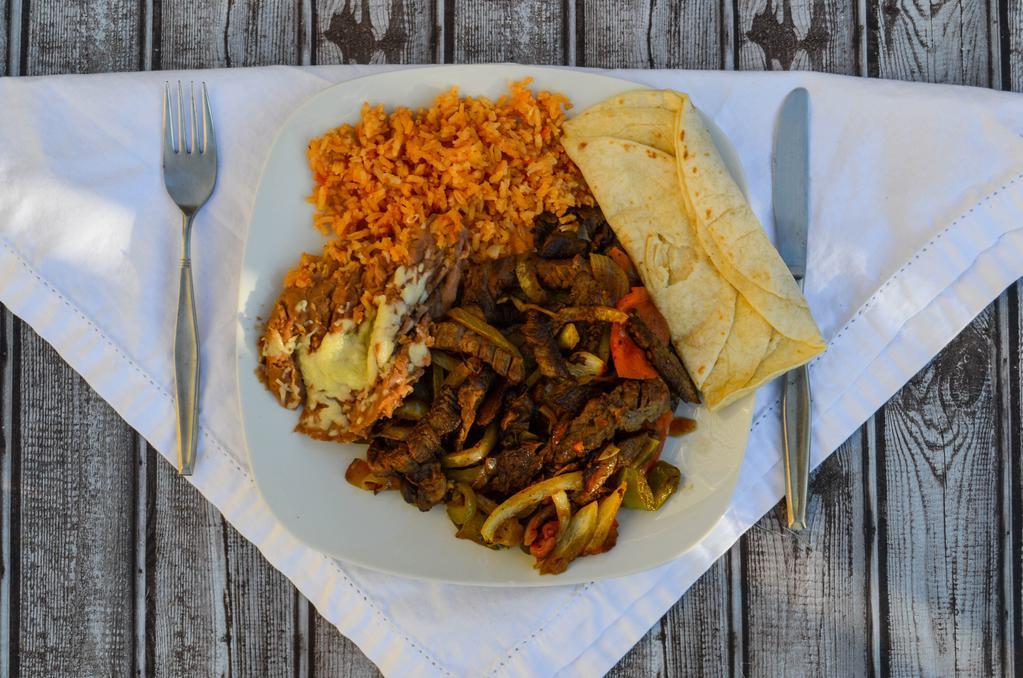 Fajitas · Grilled steak, bell peppers, onions, and tomatoes. Served with rice, beans, salad, and tortillas.