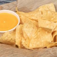 Chips & Queso · Tortilla chips with a bowl of queso.