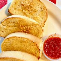 Garlic Bread · Slices of our homemade Italian artisan bread covered with a garlic butter sauce.