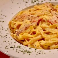 Pollo Al' Amedeo'S · Grilled chicken breast mixed with our homemade creamy Alfredo sauce and served over your cho...