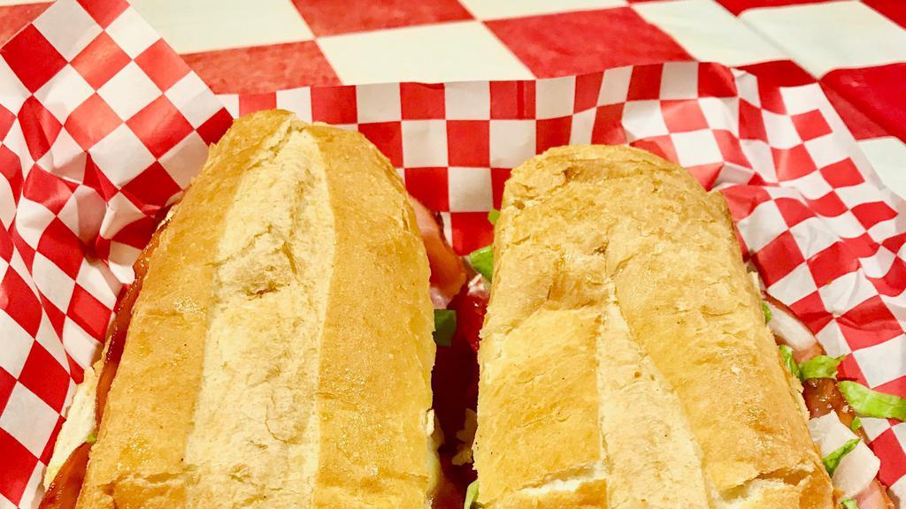 Italian Sub · Served hot or cold with sliced salami, ham, pepperoni, provolone, lettuce, tomatoes, white onions, mayo and mustard, drizzled with our homemade vinaigrette dressing. Served with a pickle and chips on a fresh hoagie roll.