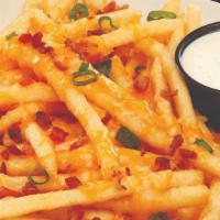 Campfire Cheese Fries · Seasoned fries topped with Cheddar Jack cheese, crisp bacon, and green onions. Served with o...