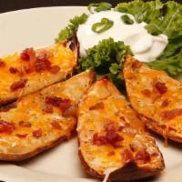 Potato Skins · Crispy potato skins loaded with Cheddar Jack Cheese and bacon. Served with sour cream for di...