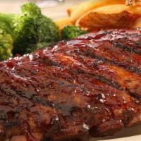 Fall Of The Bone Baby Back Ribs · Baby Back ribs grilled over an open flame and basted with our signature BBQ sauce. Served wi...