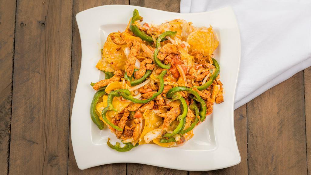 Fajita Nachos · Choice of chicken or steak. Served on a bed of crispy nachos with queso, grilled peppers, onions, sour cream, lettuce and tomato.