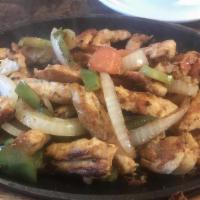Chicken Fajitas · Grilled with peppers, onions and tomatoes. Served with rice, refried beans, three tortillas ...