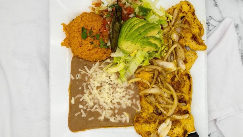 Pollo A La Plancha · Grilled boneless chicken breast topped with onion, served with lettuce, tomatoes, avocado and sour cream. Served with rice and beans.