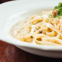 Fettuccine Alfredo · Creamy house made Alfredo sauce and choice of protein, served over warm fettuccine pasta and...