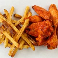 Wing Combo (8) · Eight bone-in wings with hand-cut fries and ranch. Buffalo wings pictured here.