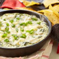 Spinach & Artichoke Dip · Sautéed spinach and artichokes in a creamy, 3-cheese sauce. Served with Dixie Tater Chips®.