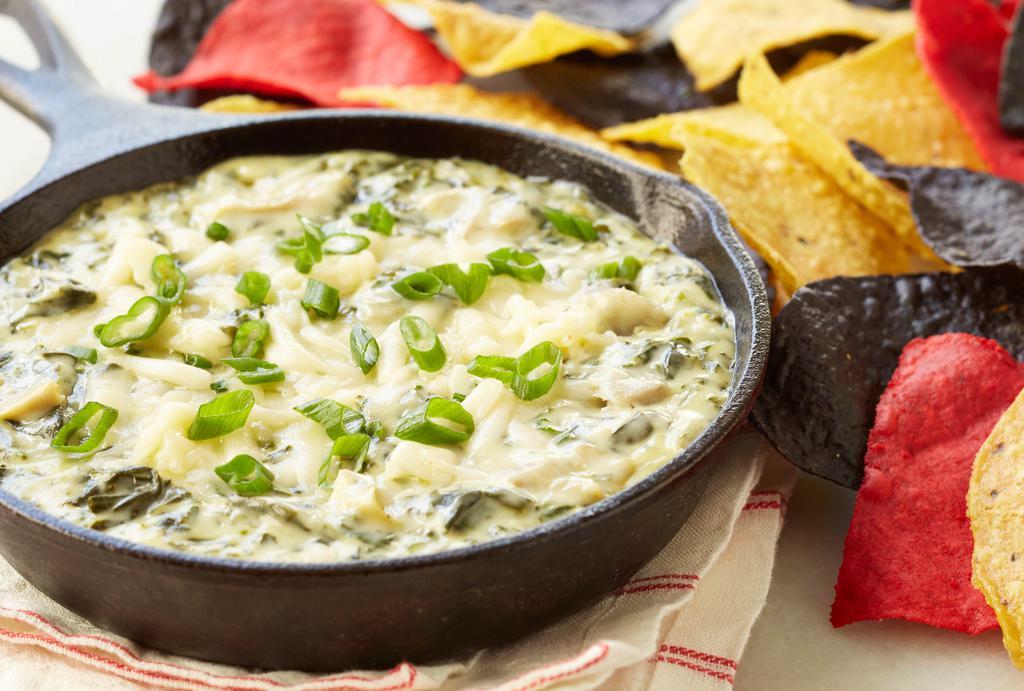 Spinach & Artichoke Dip · Sautéed spinach and artichokes in a creamy, 3-cheese sauce. Served with Dixie Tater Chips®.