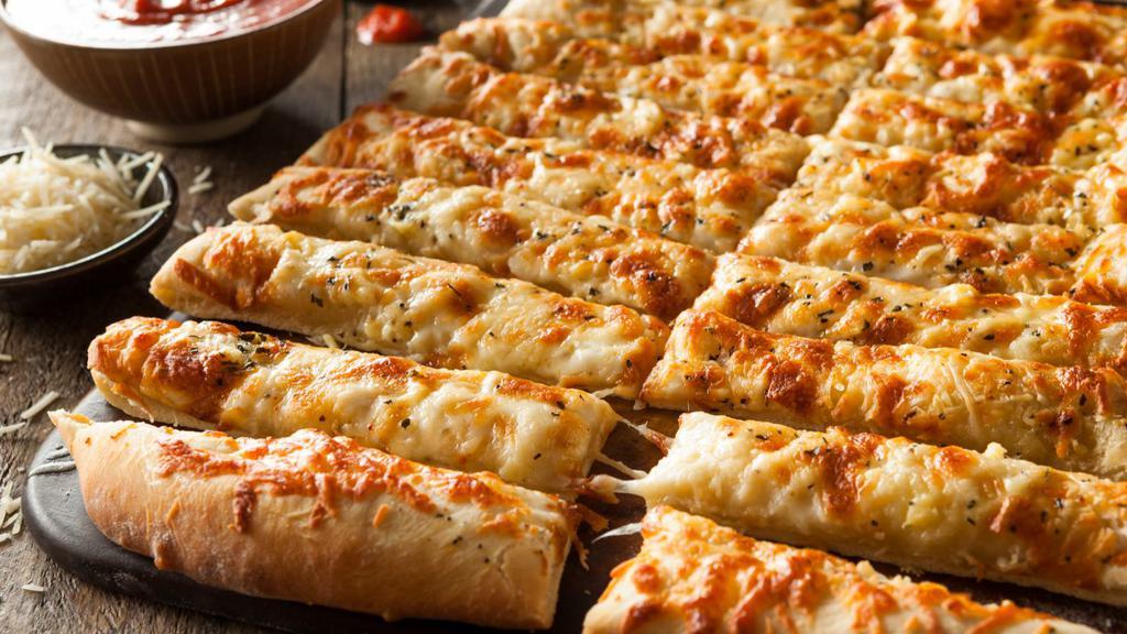 Cheesy Bread · Fresh round dough brushed with olive oil, garlic butter layered on mozzarella and cheddar cheese, served with marinara sauce.