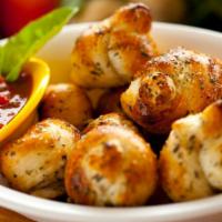 Garlic Knots · Freshly baked knots made with garlic, virgin olive oil, oregano and parsley with parmesan ch...