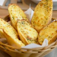 Garlic Bread · Italian bread with melted cheese, garlic butter, oregano, parsley, served with marinara sauce.