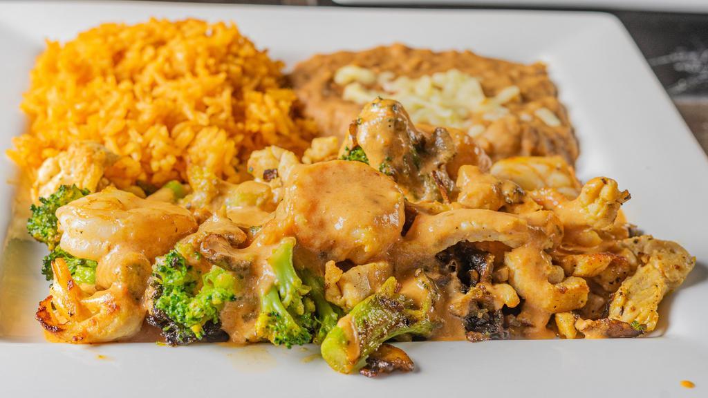 Chef'S Special · Grilled chicken and shrimp simmered and smothered. with broccoli, mushrooms and our creamy tomato. cheese sauce. Served with rice and refried beans.