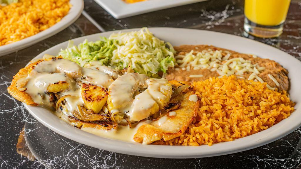 Pollo Loco · Grilled chicken topped with melted cheese, onions,. mushrooms and pineapple. Served with fresh. guacamole salad, rice and refried beans.