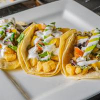 Baja Tacos · Three corn tortillas filled with crispy deep fried cod fish, fresh mixed greens, mango salsa...