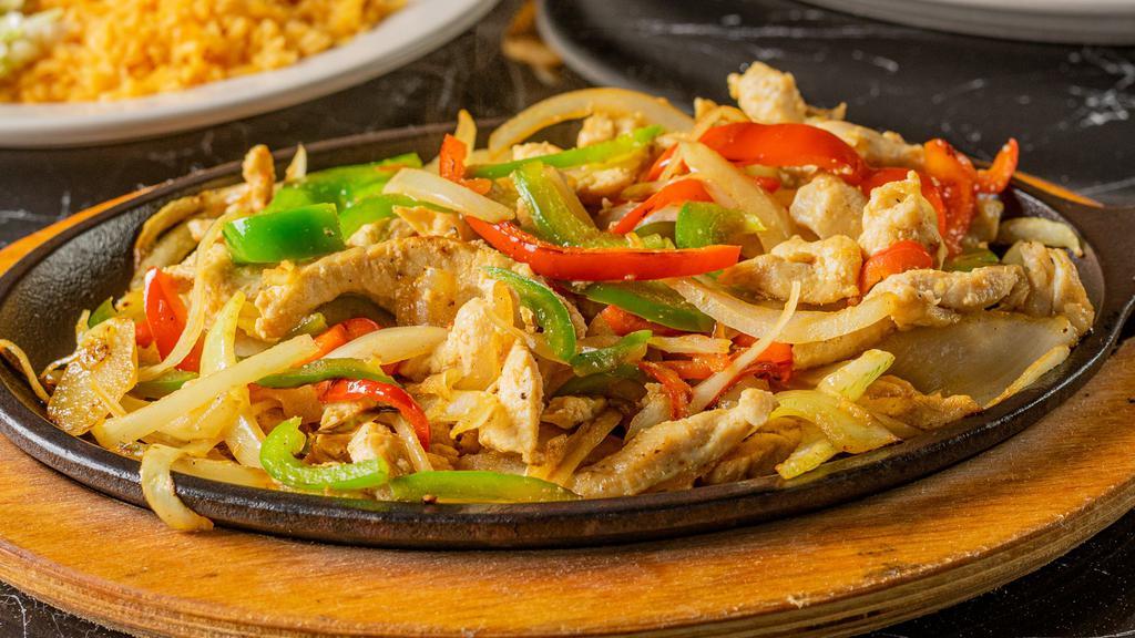 Chicken Fajitas · sautéed fresh vegetables.Served with rice, refried beans, fresh guacamole salad, sour cream and warm tortillas.