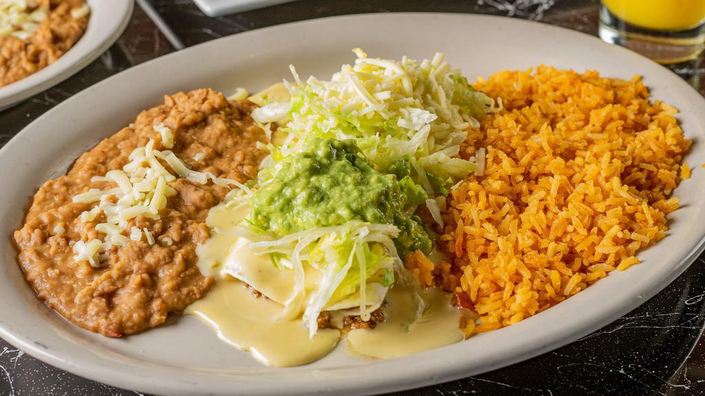 Burrito Mexicano · A flour tortilla filled with your choice of shredded. chicken, beef or pork. Topped with cheese sauce,. lettuce, and homemade guacamole. Served. with rice and refried beans.