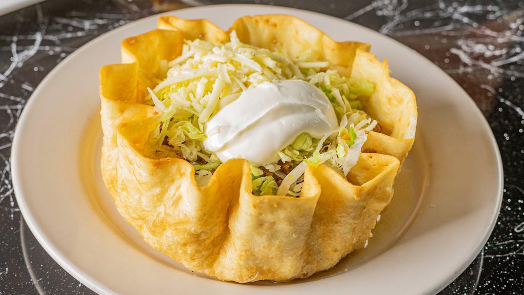Taco Loco · A large crispy flour tortilla filled with shredded chicken. or ground beef topped with shredded cheese, lettuce,. and sour cream.