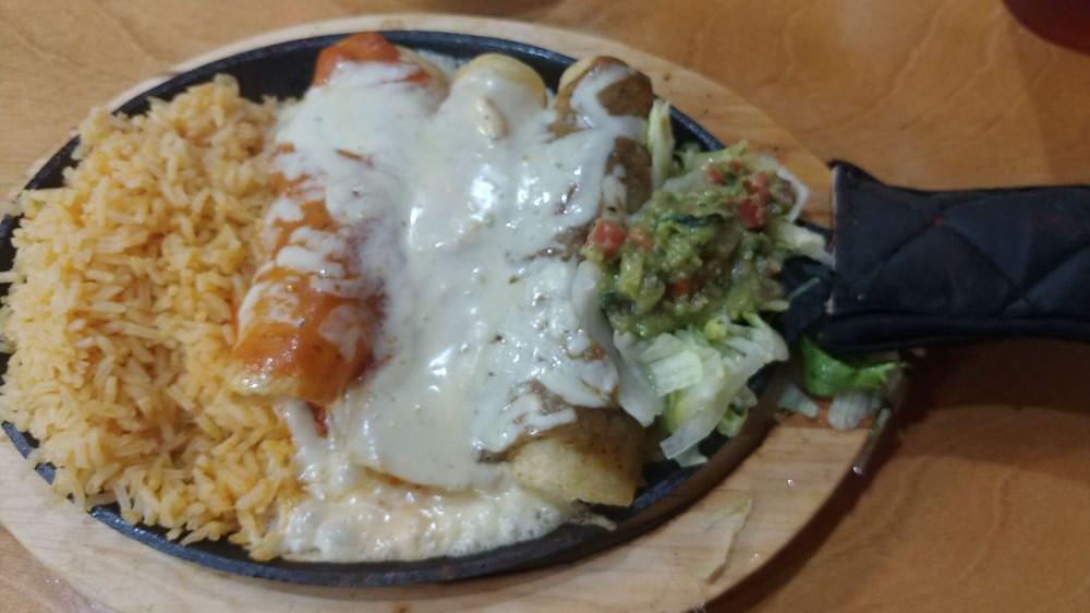 Sizzling Enchiladas · 3 enchiladas, 1 filled with cheese and steak , 1 filled with cheese and chicken, and 1 filled with cheese topped with queso dip, other 2 topped with ranchera sauce and green tomatillo sauce.
Served with rice, frijoles de la olla(black beans),lettuce, and guacamole.