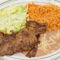 Carne Asada · Steak served with rice, beans, lettuce, dressing, and tortillas.