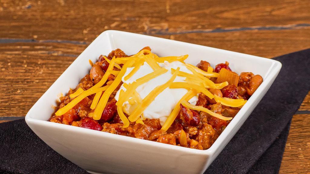 Steakhouse Chili · Hereford ground beef combined with seasonings, peppers, onions, and tomato topped with Cheddar cheese and sour cream.