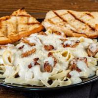 Chicken Fettuccine Alfredo · Grilled chicken and Fettuccine tossed in a homemade Alfredo sauce. Served with house salad a...