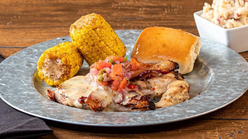 Southwestern Chicken · Two grilled chicken breasts topped with crispy bacon, Swiss cheese, and housemade pico de gallo. Served with choice of two sides.