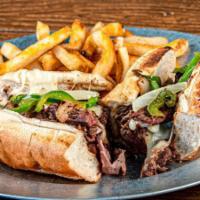 Philly Cheesesteak · Thinly sliced sirloin piled on a sub roll with sautéed peppers and onions topped with melted...