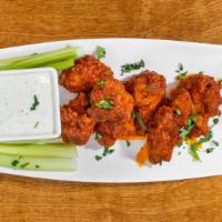 Buffalo Wings · Lightly breaded and fried in spicy wing sauce, served with ranch dressing.