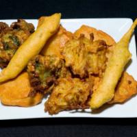 Assorted Pakora · Fresh vegetables dipped in a delicately spiced batter and fried to golden perfection.