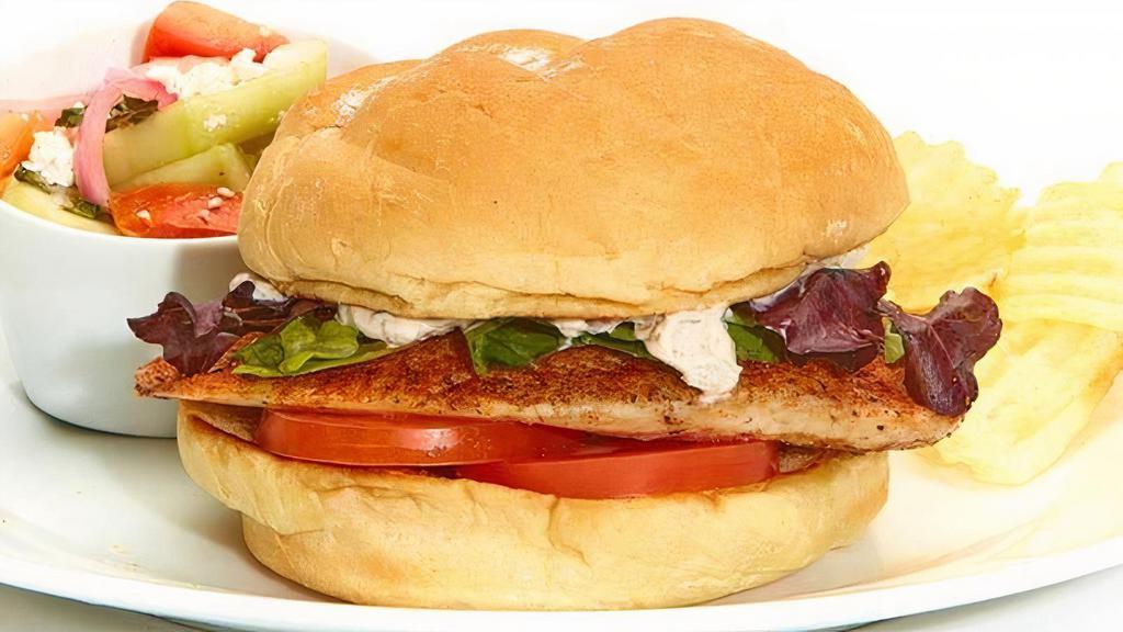 Grilled Tilapia Sandwich · With caper-dill tartar sauce. Grilled and served with tomato and lettuce on a kaiser bun. Served with chips and your choice of a homemade side.