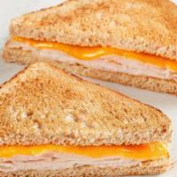 Kids Turkey Toastie · American cheese with turkey on toasted wheat bread. Comes with your choice of a side and a M...