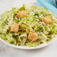 Side Caesar Salad · Crisp romaine lettuce tossed with parmesan cheese and croutons and a side of Caesar dressing.