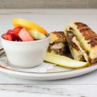 Chicken Pesto Panini · Grilled chicken brushed with pesto, sautéed red peppers, onions and gruyere cheese. On sourd...