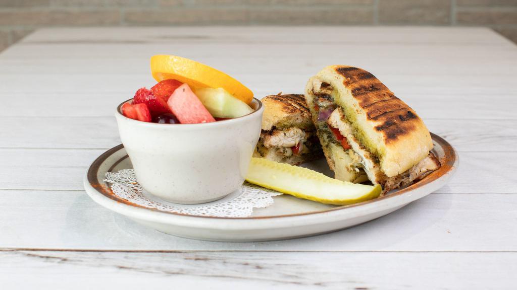Chicken Pesto Panini · Grilled chicken brushed with pesto, sautéed red peppers, onions and gruyere cheese. On sourdough bread brushed with olive oil.