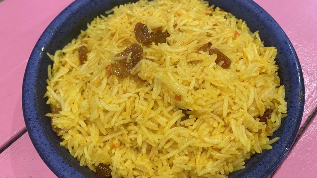 Turmeric Rice · Basmati rice, fresh turmeric, golden raisins, ghee.