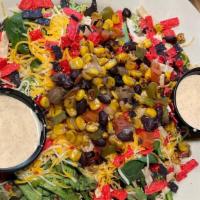 Fajita Salad · Southwest inspired Salad with a black bean corn salsa, cheddar cheese, tortilla strips, and ...