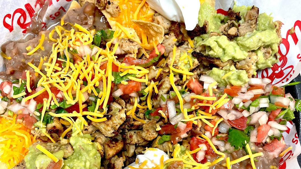 Super Nachos · Choice Of Meat , Beans, Guacamole, Pico de Gallo, Sour Cream, Lettuce and  Cheese all on a bed of chips