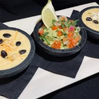 Dip Sampler · Chile con queso, guacamole, and bean dip.
