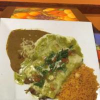 Burrito A La Roqueta · A tender roast pork burrito topped with salsa verde and pico de gallo. Served with rice and ...