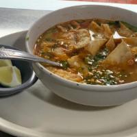 Chicken Tortilla Soup · Crispy fried strips of corn tortilla in  & tomato-based Mexican soup with a chicken stack, s...